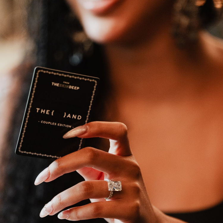 Person holding a product with 'The And' branding, wearing a ring.