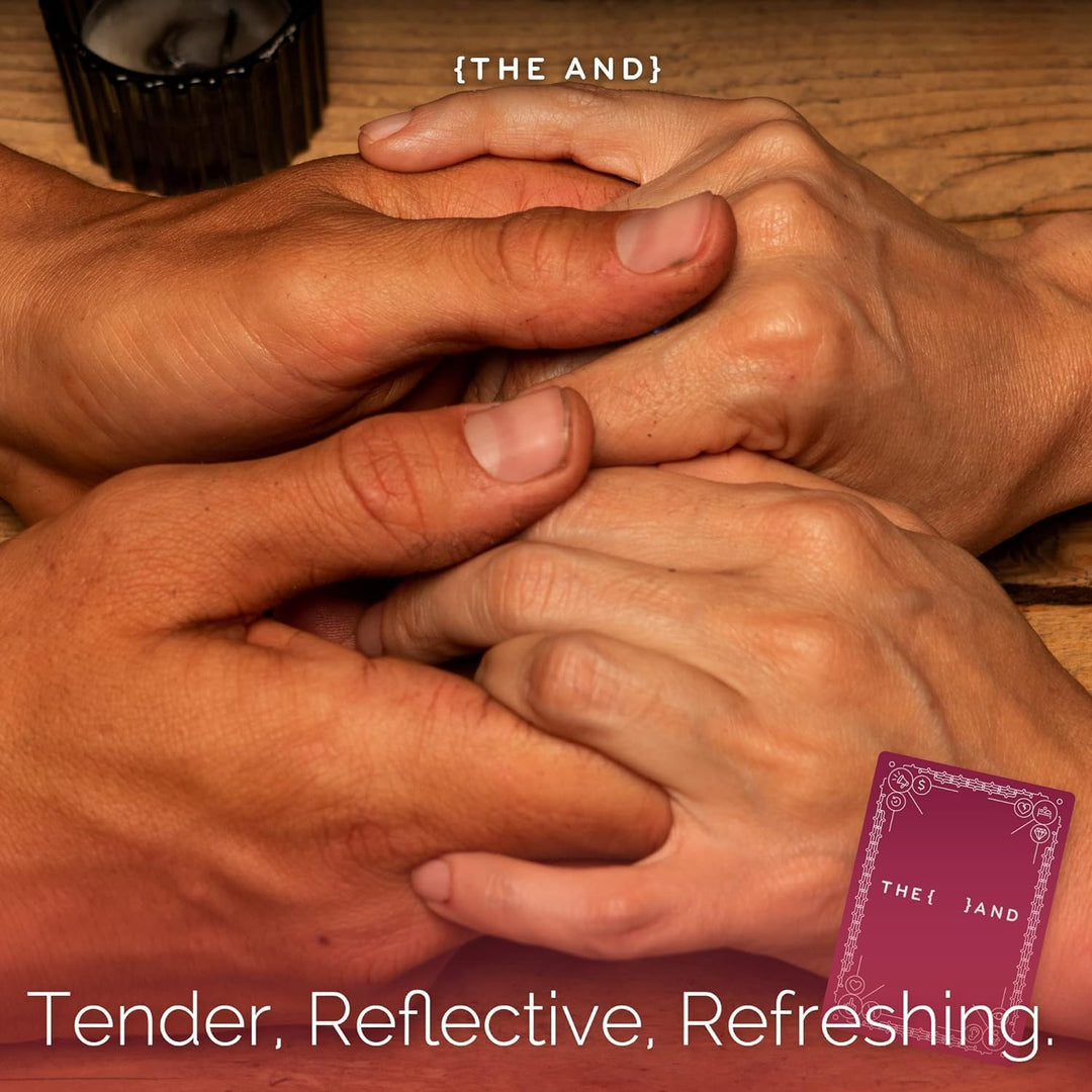 Two pairs of hands interlocked on a wooden surface with a purple card labeled 'THE AND' in the corner.