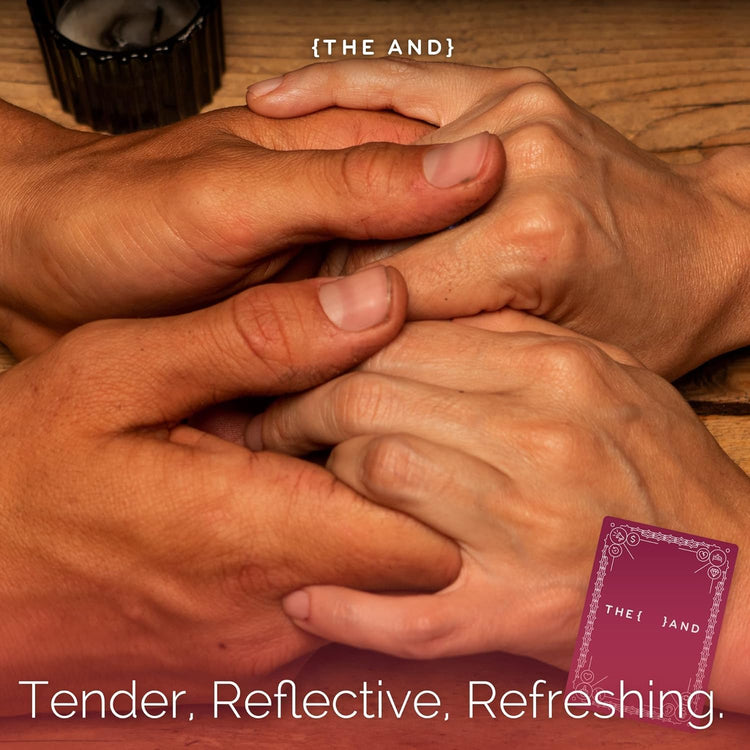 Two pairs of hands interlocked on a wooden surface with a purple card labeled 'THE AND' in the corner.