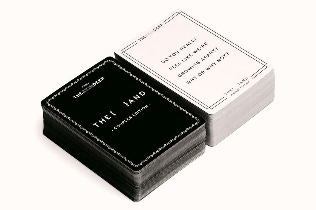 Black and white card game box with cards on a white background